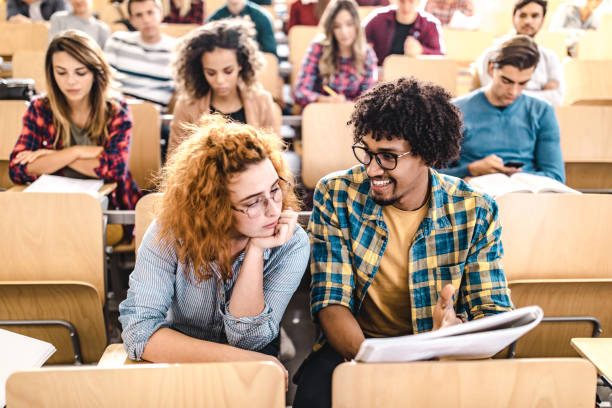 istock Young college students cooperating on a class at lecture hall. 1091219690