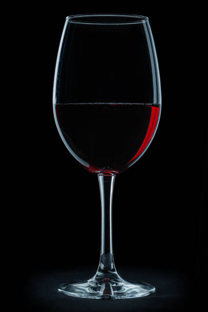 istock glass with red wine isolated on black background. 1091219792