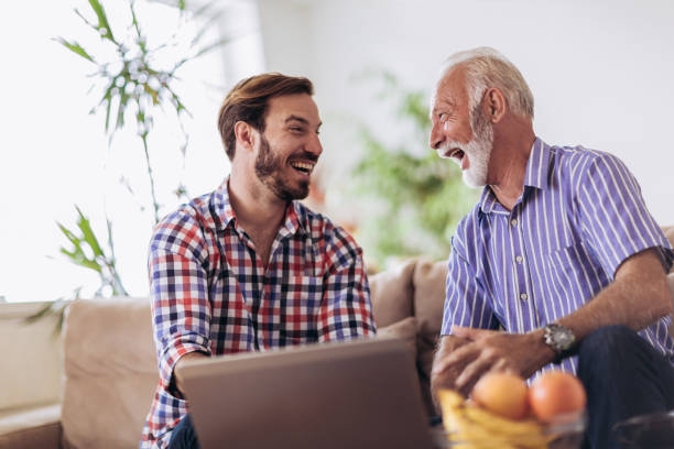 istock Adult Son Helping Senior Father With Computer At Home 1091220416