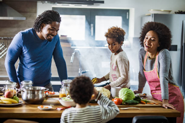 istock Happy African American family talking while preparing meal in the kitchen. 1091225698