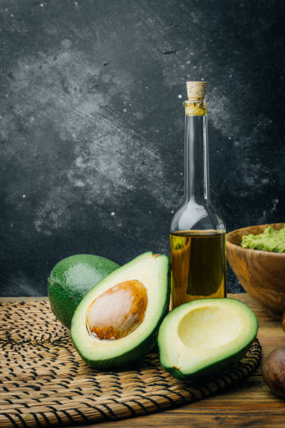 istock Avocado and avocado oil on a wooden background. Copy space. 1091227150
