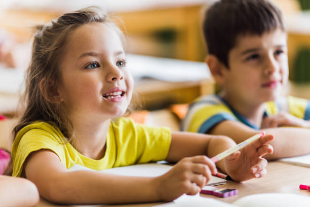 istock Happy schoolgirl paying attention on a class at elementary school. 1091228302