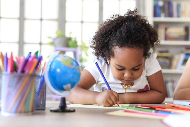 istock Little girl drawing at home 1091231182