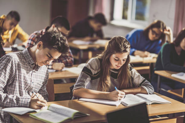 istock Group of high school students writing an exam in the classroom. 1091231244