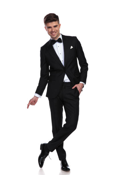 istock relaxed joyful businessman stands cross-legged and points to side 1091232822