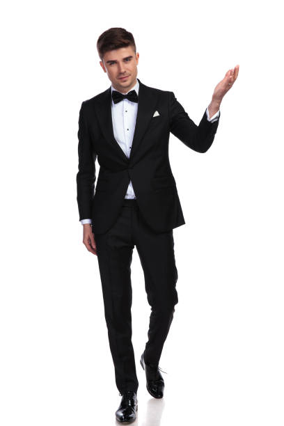 istock young handsome man in black tuxedo presents to side 1091233014
