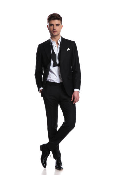 istock relaxed elegant man in tuxedo standing with legs crossed 1091233464