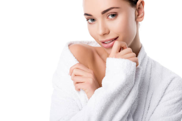 istock beautiful woman in bathrobe looking at camera isolated on white 1091234088