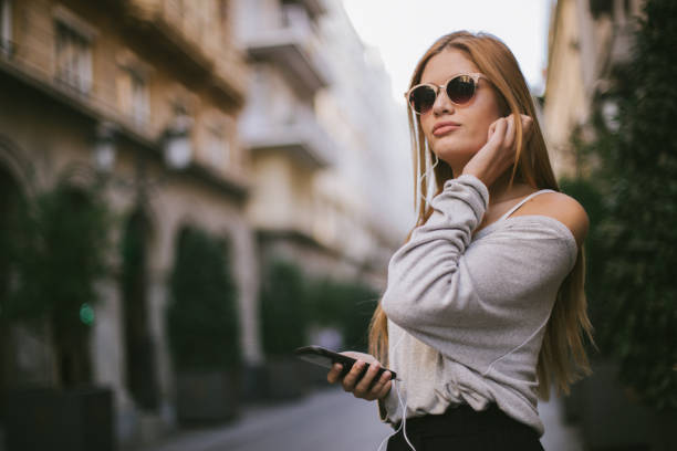 istock Young woman in city using mobile phone 1091242458