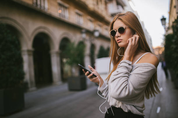 istock Young lady in city using mobile phone on the street 1091242686