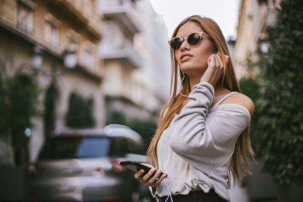 istock Blonde lady using mobile phone on the street 1091243396