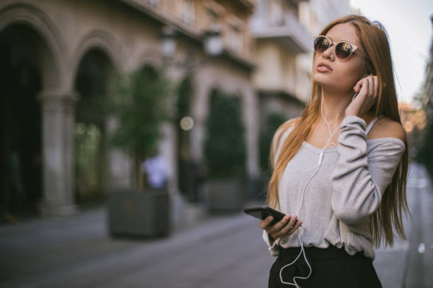 istock Blonde lady using mobile phone on the street 1091243418