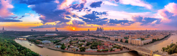 istock Wide angle panoramic view of sunset above Moscow wth cloud reflections in city river, traveling boats and bridge 1091243734
