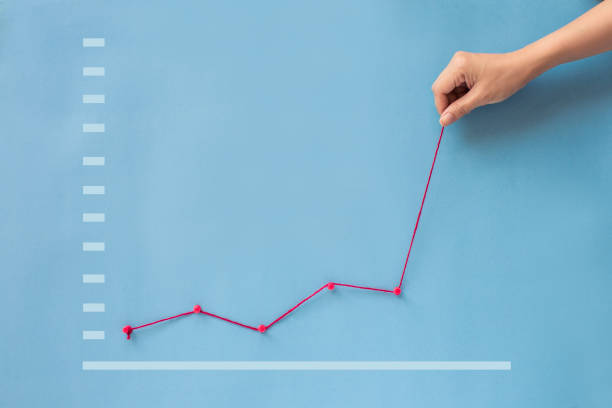 istock Conceptual hand pulling business finance growth chart still life. 1091245894