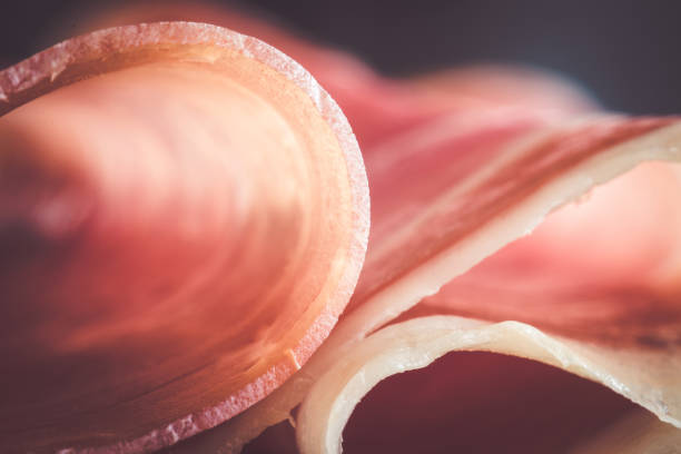 A macro shot of a tasty slice of prosciutto, front view, studio shot.