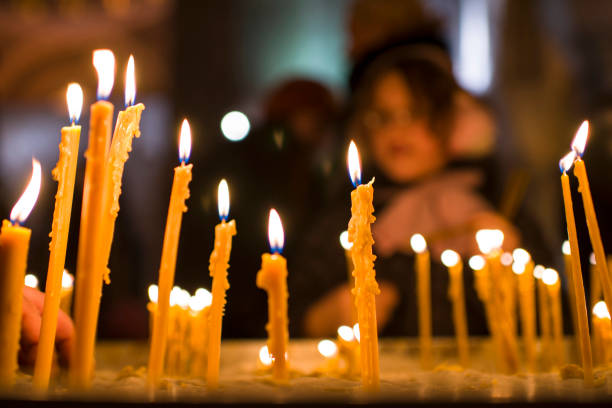 istock People behind candles in a church 1091246982