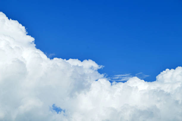 istock A horizontal click of white bright clouds in open bright blue sky. 1091247366
