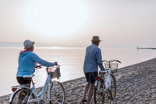 Active seniors couple on bike at the summer vacation