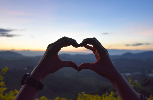 istock look through hand and heart,mountain sun and sky,sunrise 1091251082