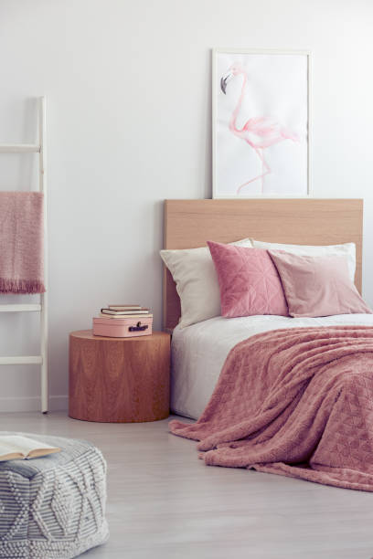 Pink pillows and blanket on white bedding in fashionable girl's bedroom interior Pink pillows and blanket on white bedding in fashionable girl's bedroom interior pink bed stock pictures, royalty-free photos & images