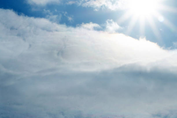 istock blue sky with rays of the sun and clouds . 1091261520