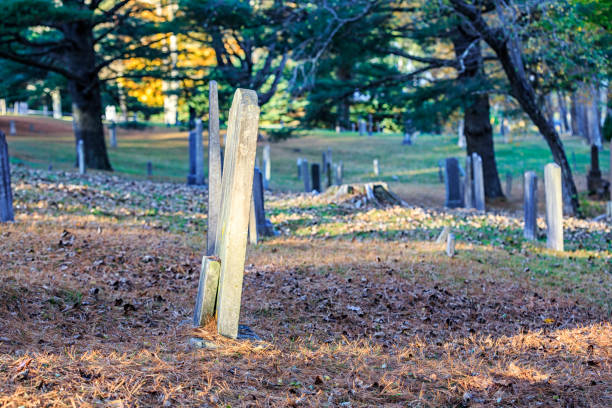 istock Small Headstone Leaning Against Larger Tombstone in Rural Cemetery 1091262592