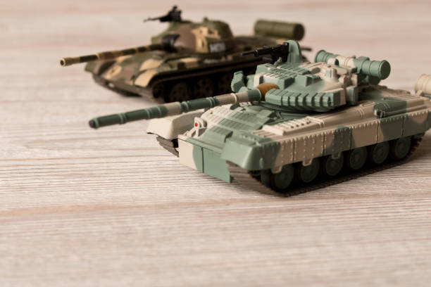 istock Toy models of Soviet tanks on a wooden table. 1091268730
