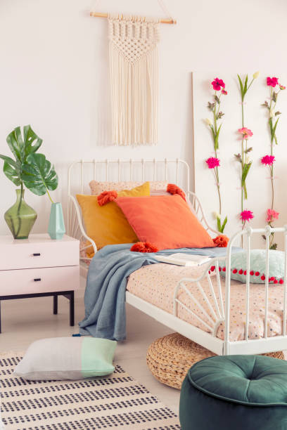 istock White handmade macrame above above single metal bed with colorful pillows and patterned duvet, real photo 1091272258