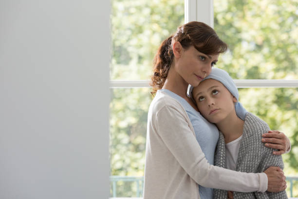 istock Caring mother hugging sick daughter with cancer during chemotherapy 1091284702
