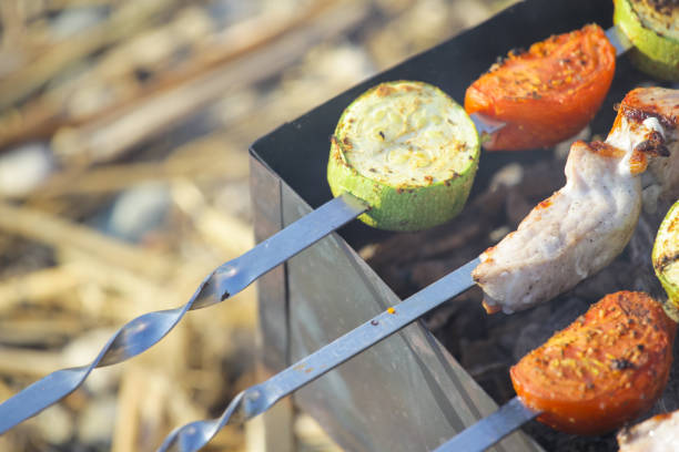 cooking vegetables and meat on charcoal