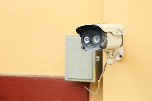 istock Watching you, Funny face CCTV or Security camera installed on the wall. 1091303534