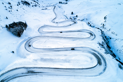 Aerial view of winding, almost completely snow covered Julier Pass in Switzerland.