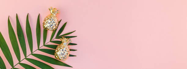 Creative pink background with tropical palm leaves