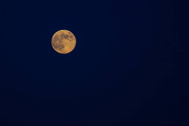 istock orange full moon on the dark blue sky 1091307410