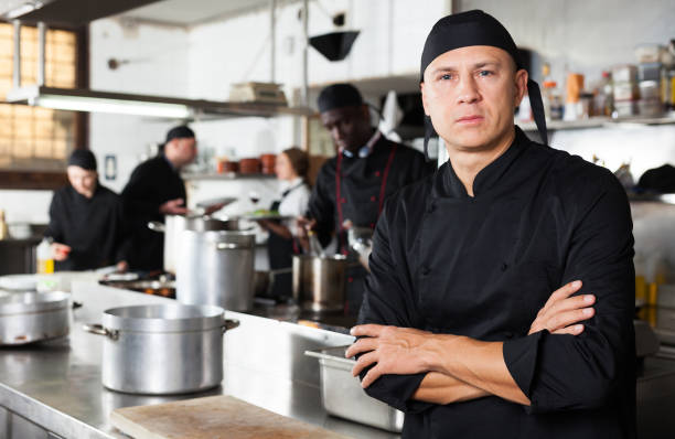 istock Confident male chef posing at restaurant kitchen 1091309338