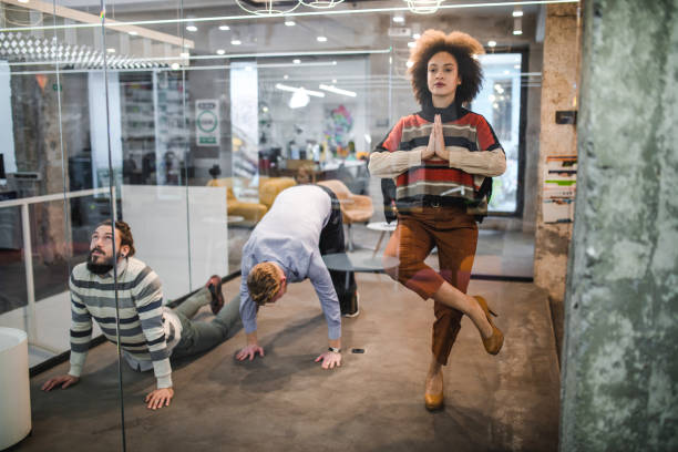 group of entrepreneurs exercising at casual office. - yoga meditating business group of people imagens e fotografias de stock