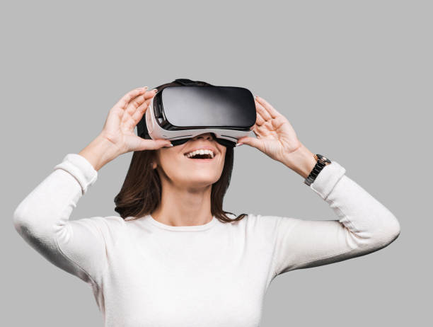 istock Young woman experiencing virtual reality eyeglasses headset 1091316768