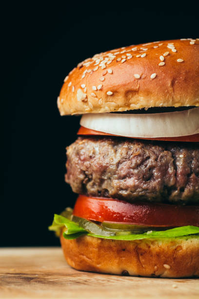 istock Delicious tasty burger on wooden table 1091316994