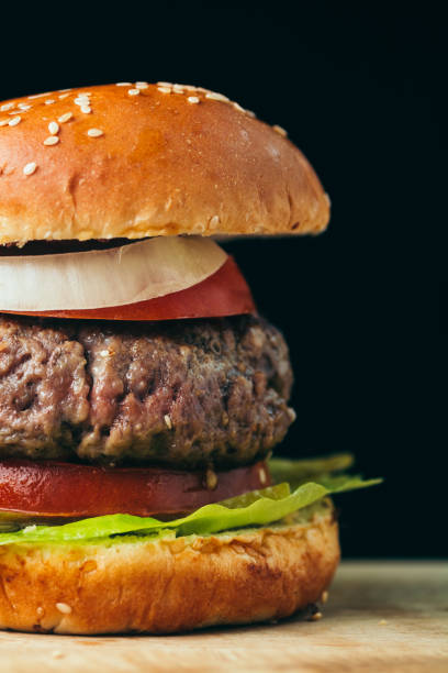 istock Delicious tasty burger on wooden table 1091317254