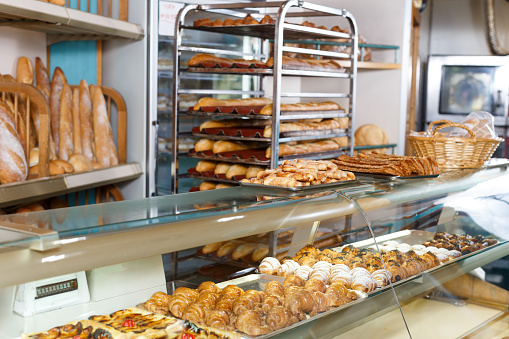 View of bakery glass display full of various appetizing confectioneries