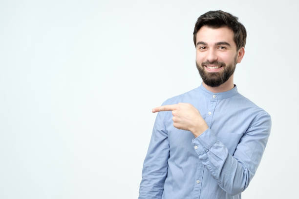 istock Stylish handsome young hispanic man pointing aside. 1091320120