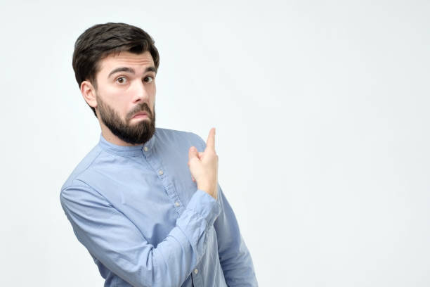 istock Stylish handsome young hispanic man pointing aside. 1091320142