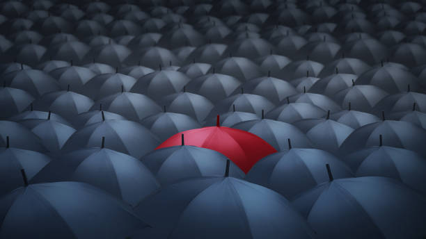 istock businessman with red umbrella among others, unique different concept 1091323682