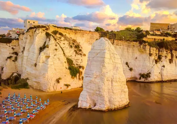 Vieste - Gargano - Apulia - Italy - The Pizzomunno skerry during low tide sunset .