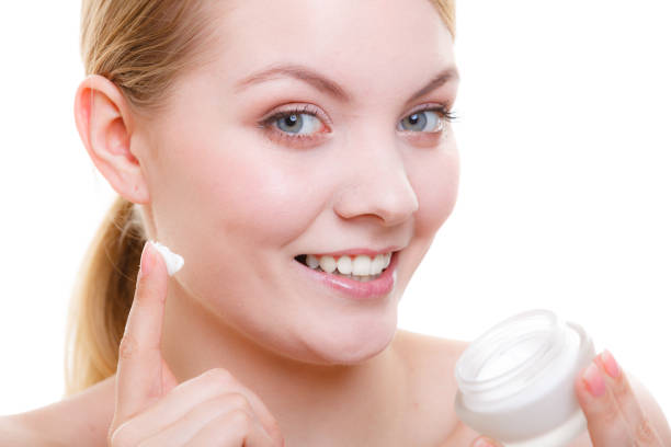 istock Woman applying face cream with her finger 1091325870