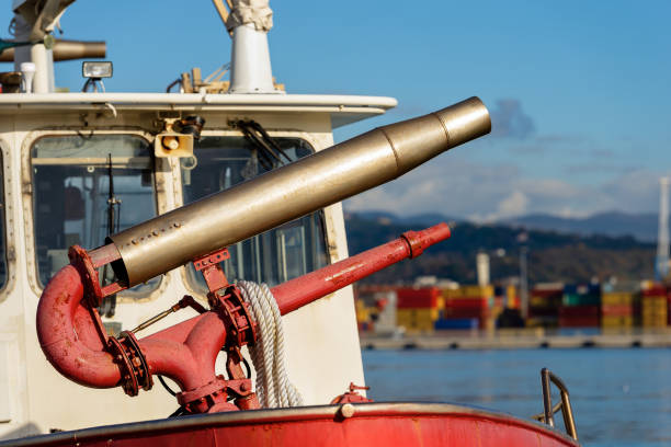 Detail of an old red water cannon aboard on a fire boat. Port of La Spezia, Liguria, Italy