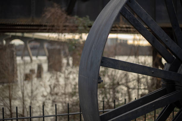 This is a view of an antique wheel that is in the canal walk park in Richmond Virginia.
