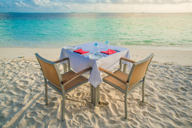 istock Table outdoor next to sea scenic prepare for special romantic dinner time. 1091335844