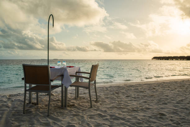 istock Table outdoor next to sea scenic prepare for special romantic dinner time. 1091335902