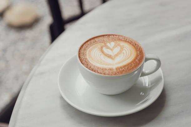istock latte or Cappuccino with frothy foam, coffee cup top view on table in cafe. 1091337856